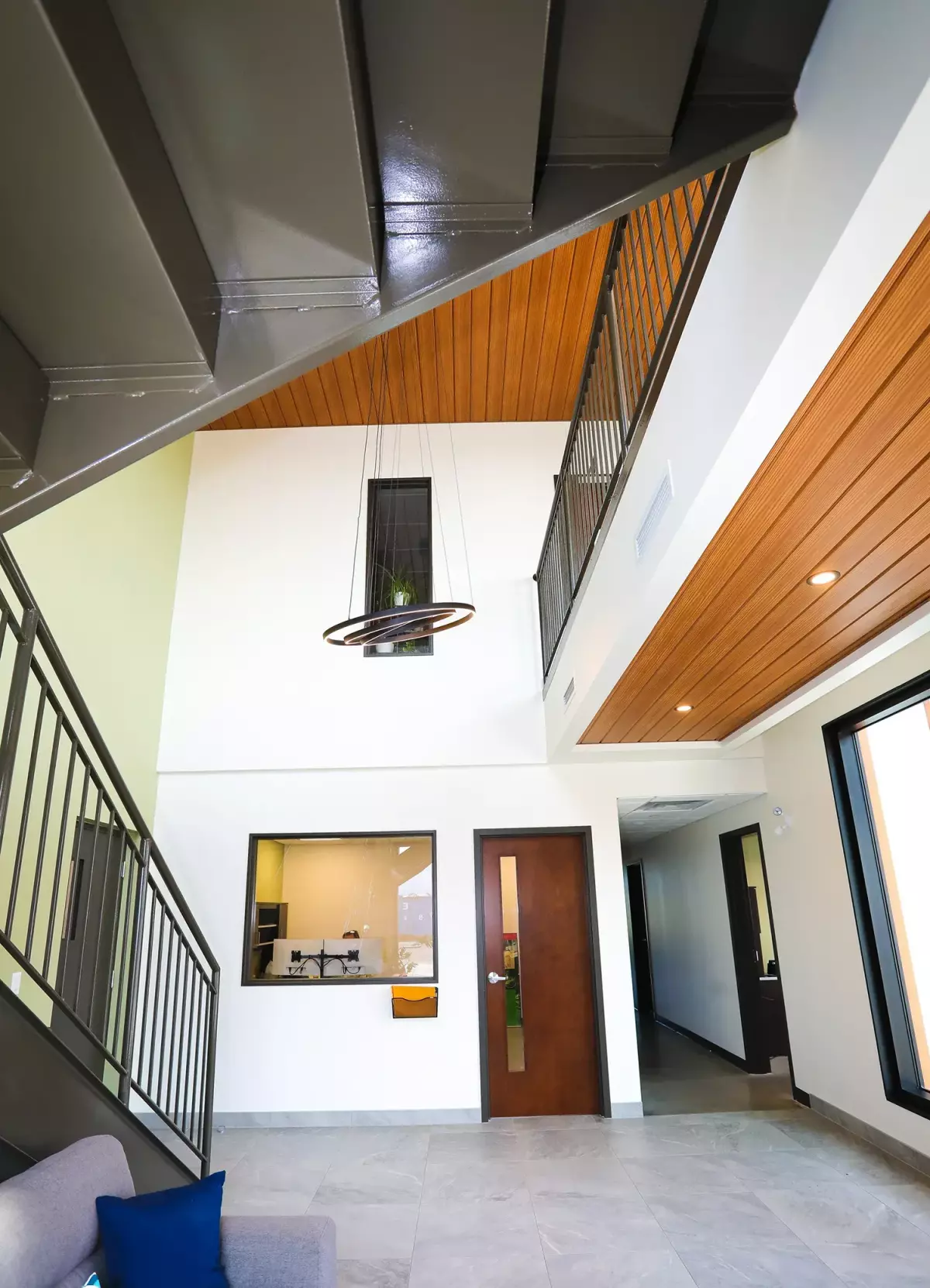 Espace à aire ouverte avec mezzanine en acier, plafond de bois et éclairage moderne – bureaux Jardins Brunelle