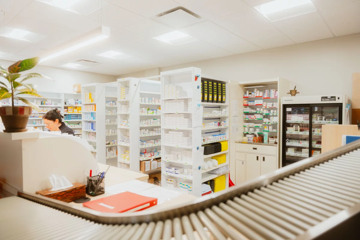 Espace de travail pharmacie avec convoyeur et système de rangement intégré
